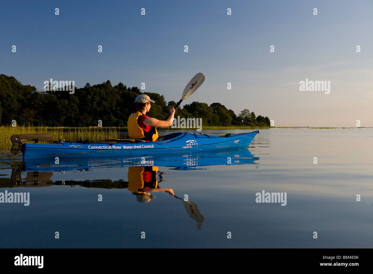 A woman kayaks in the Black Hall River near the mouth of the ...