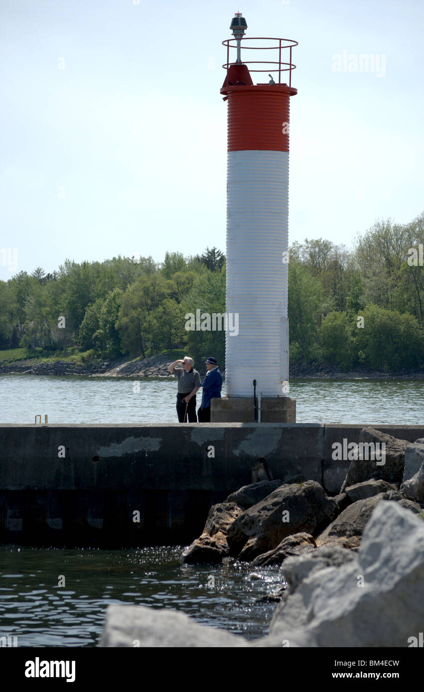 Couple searches Lake from Bronte Harborr nautical light tower in Oakville, Ontario, Canada Stock Photo