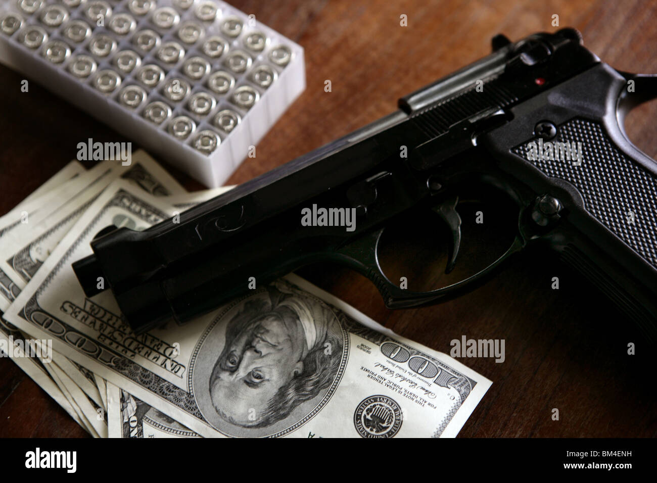 Dollar notes and gun, black pistol, mafia inspiration Stock Photo