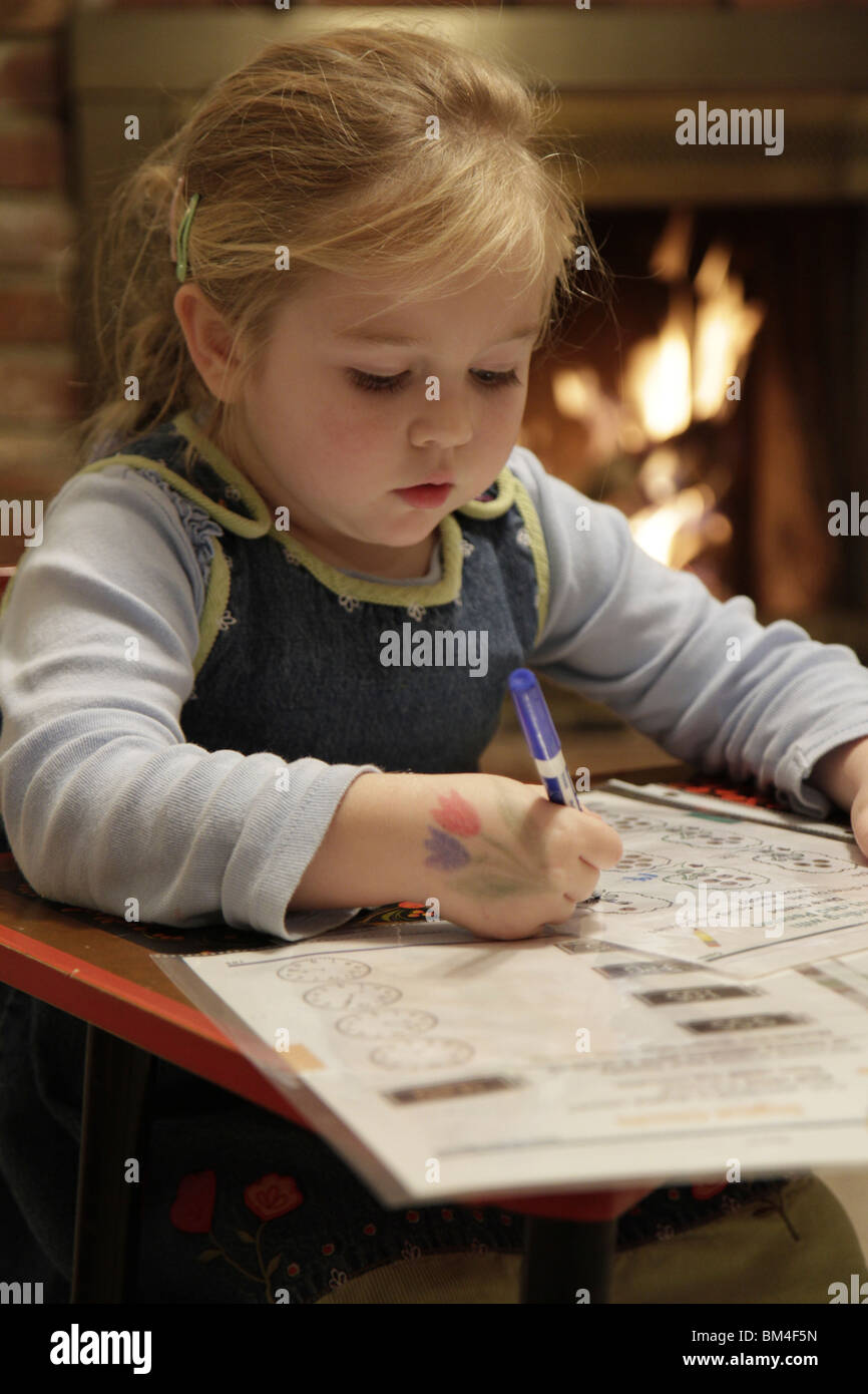 Late homework of a 5-yo girl, early education at home, USA Stock Photo