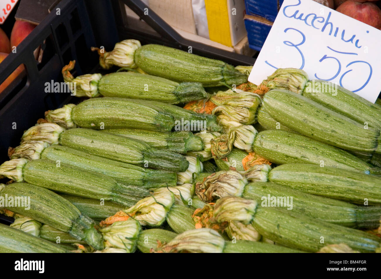 zucchini zucchinis courgette courgettes  summer squash squashes on market stall stalls fresh vegetables vegetable ripe ripened f Stock Photo