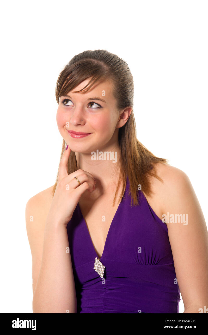 A good-looking teenage girl looks upwards contemplatively. Stock Photo