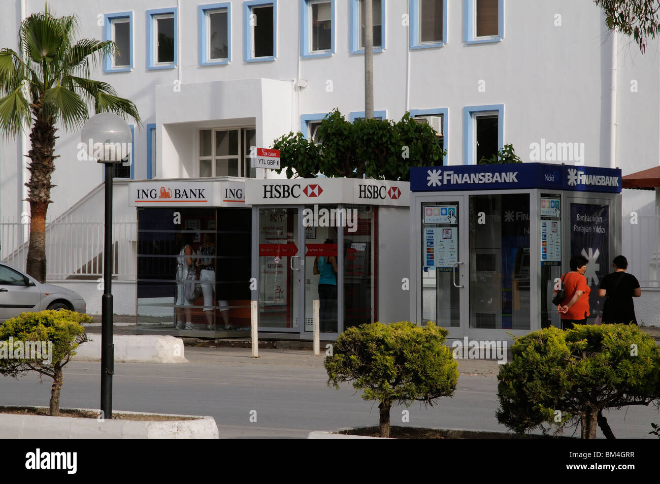 Holidaymakers using cash machines of various banks on the main street in the Turkish holiday resort of Turgutreis Bodrum Turkey Stock Photo