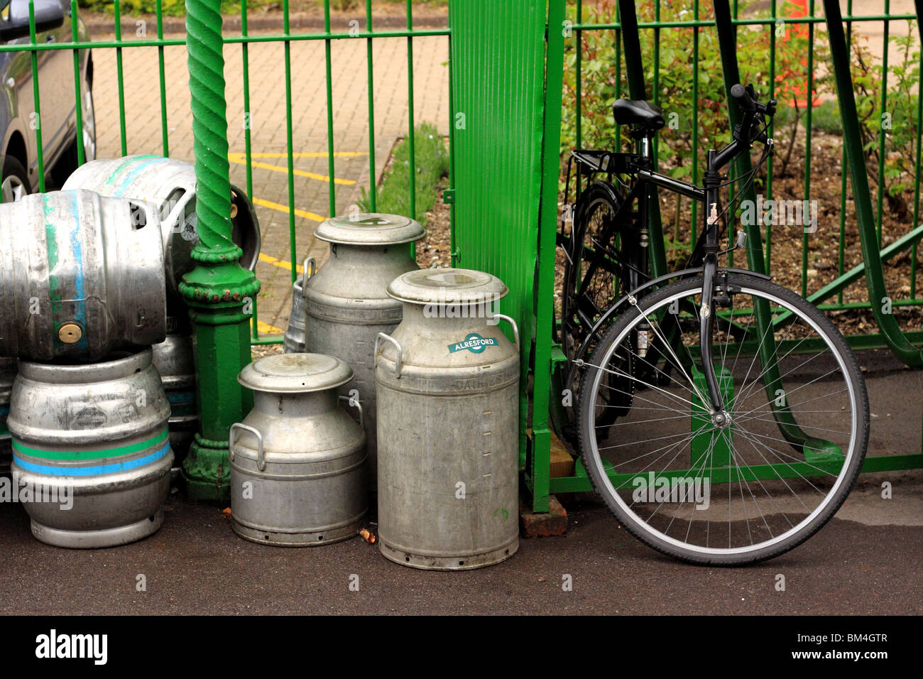 milk churns and barrels and a gents bike at Alresford Station on the Watercress Line Stock Photo