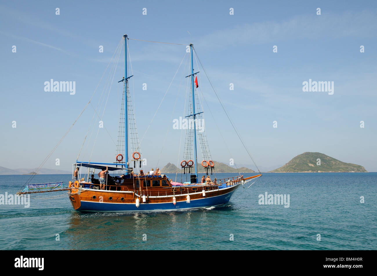 Turgutreis in the Bodrum region of south west Turkey.A wooden Gulet setting out with tourists to sail around the islands Stock Photo