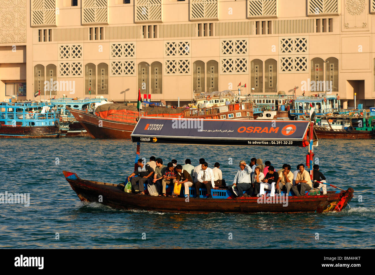 Abra water taxi with publicity for Osram bulbs on the Dubai Creek, Dubai, United Arab Emirates Stock Photo