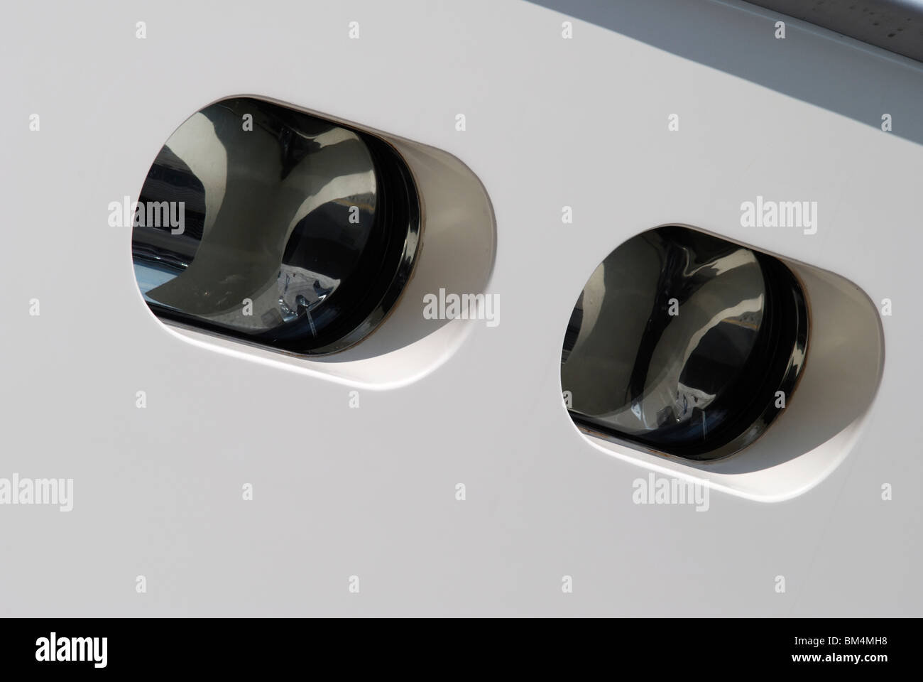 Portholes / windows in side of hull of a superyacht in Cannes harbour. France Stock Photo