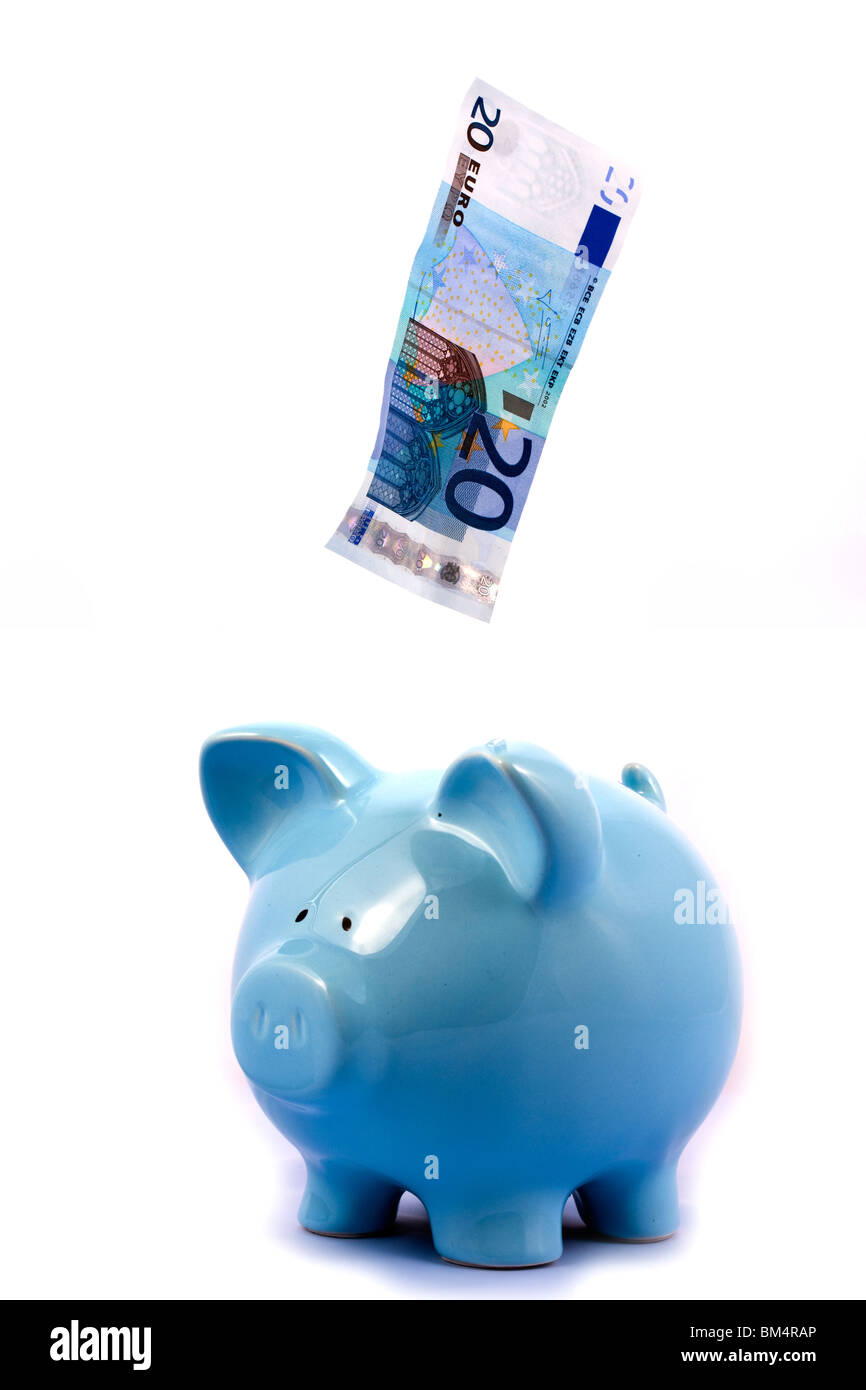Note Falling into Blue Piggy Bank on White Background Stock Photo - Alamy