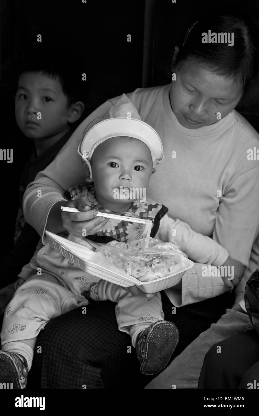 Mother Feeding Baby, Xingping, China Stock Photo
