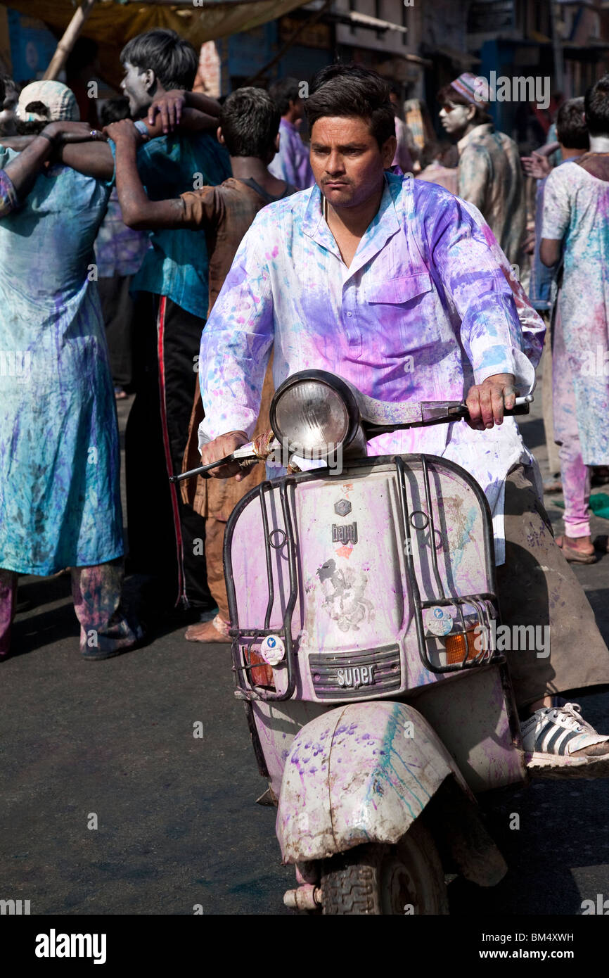 Man driving a bike during Holi festival. Varanasi. India Stock Photo