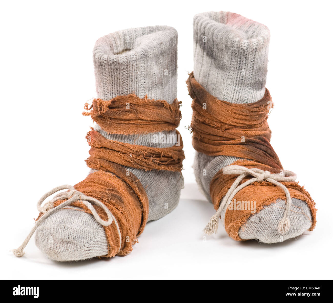 Poor mans shoes made of woolen stocking and rugs. Isolated on white. Stock Photo