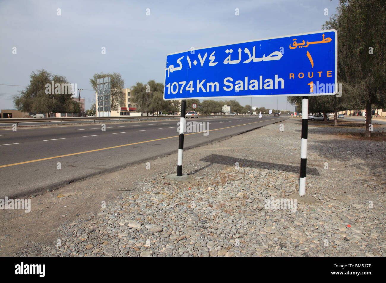 bilingual street direction sign, highway route No1 near Muscat showing 1074 km  distance to Salalah,Oman.Photo by Willy Matheisl Stock Photo