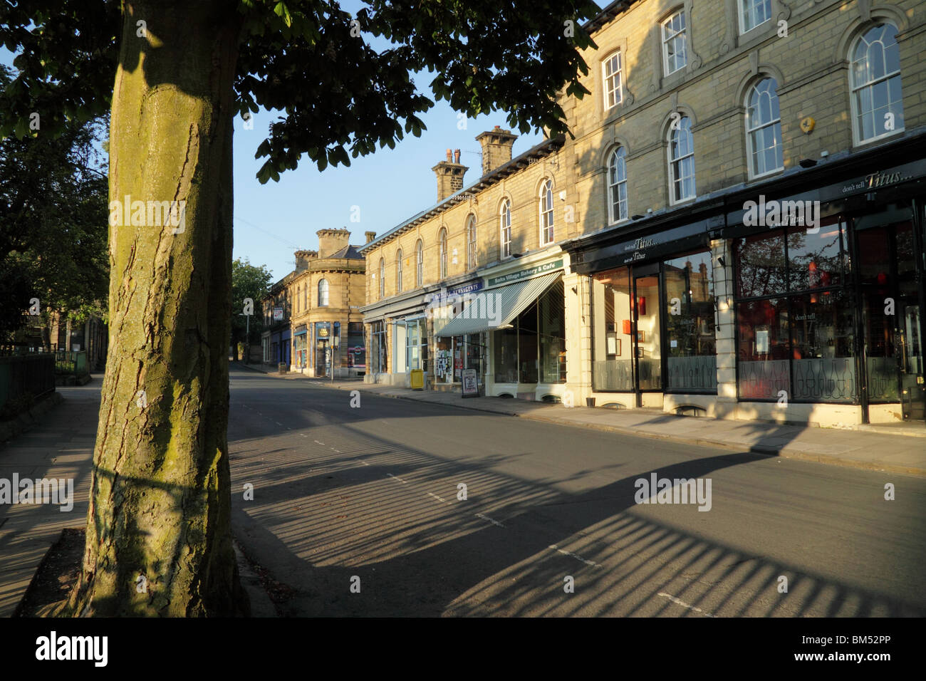 Shops on Victoria Road, in Saltaire, a UNESCO World Heritage Site in Bradford, West Yorkshire Stock Photo