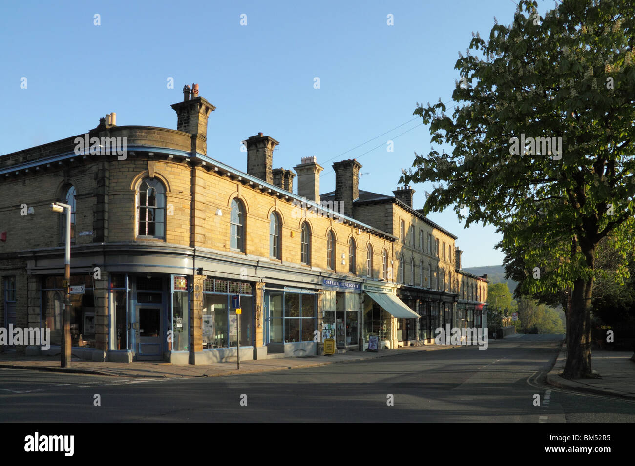 Shops on Victoria Road, in Saltaire, a UNESCO World Heritage Site in Bradford, West Yorkshire Stock Photo