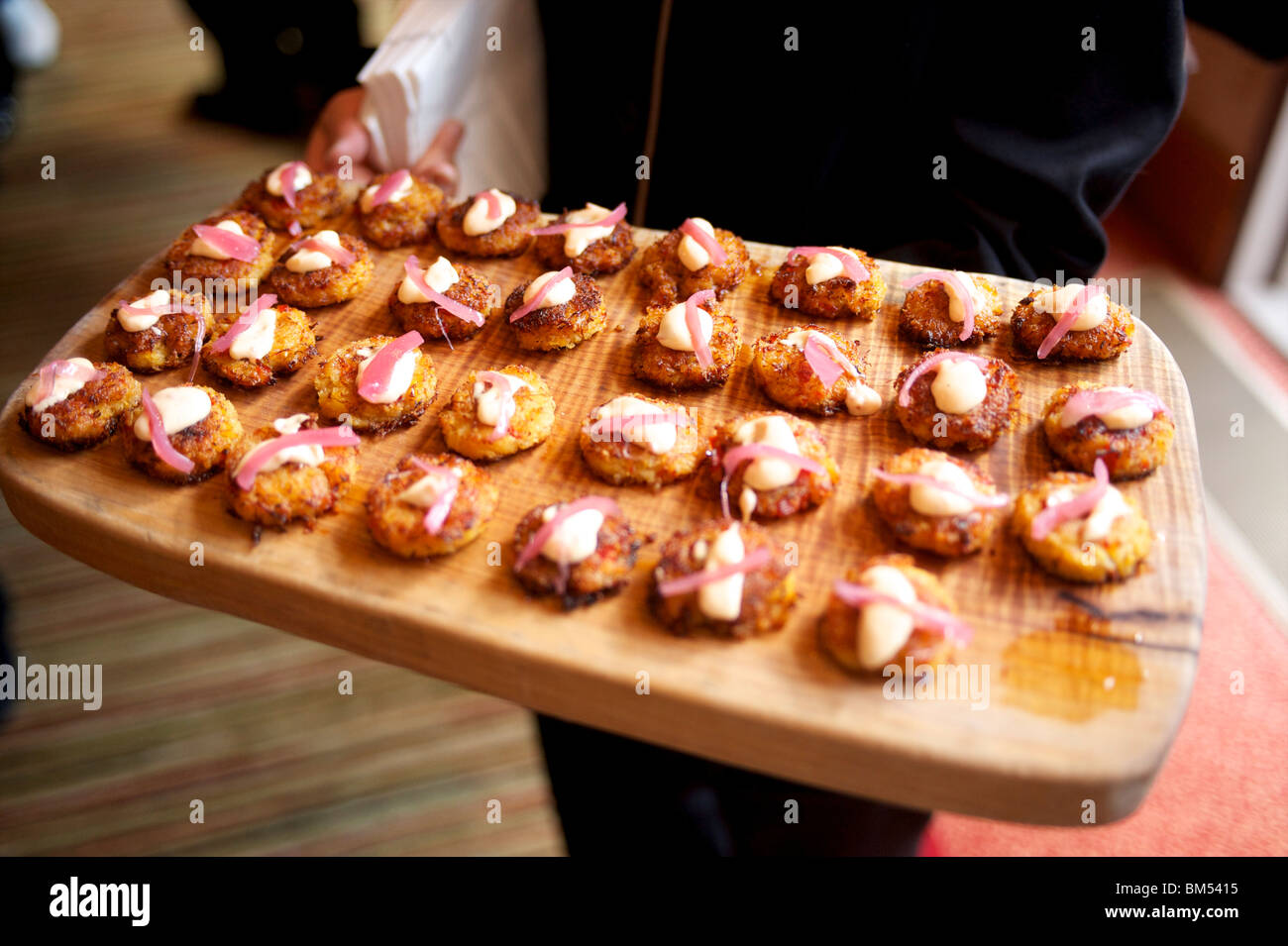 A waiter with a plate of hors d'oeuvres and appetizers. The Four Season's Resort. Whistler BC, Canada Stock Photo