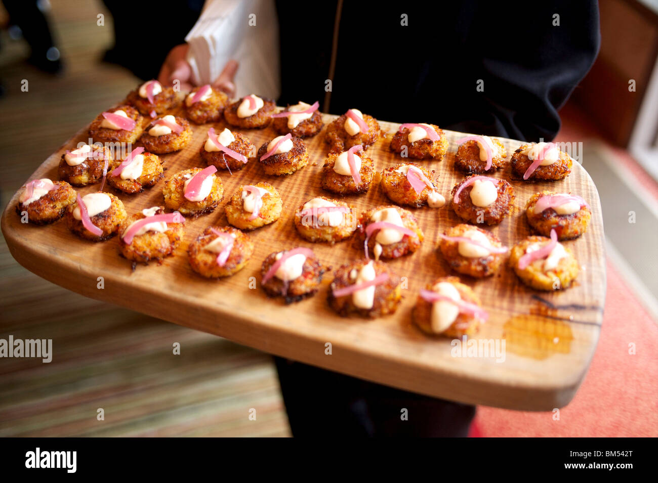 A waiter with a plate of hors d'oeuvres and appetizers The Four Season's Resort. Whistler BC, Canada Stock Photo