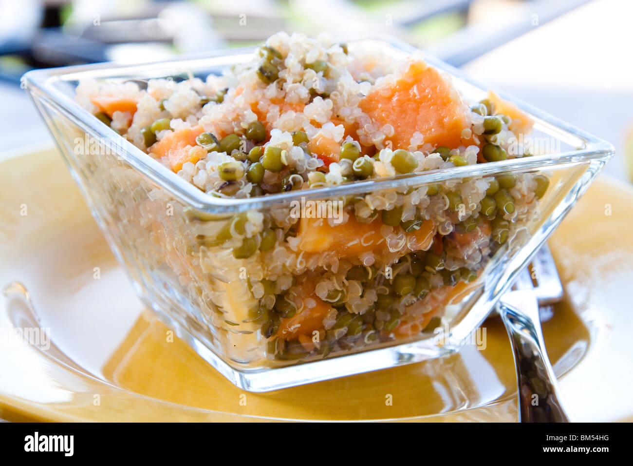 Protein rich quinoa grain salad made with sprouts and papaya. Topped with spicy dressing made with olive oil, herbs Stock Photo