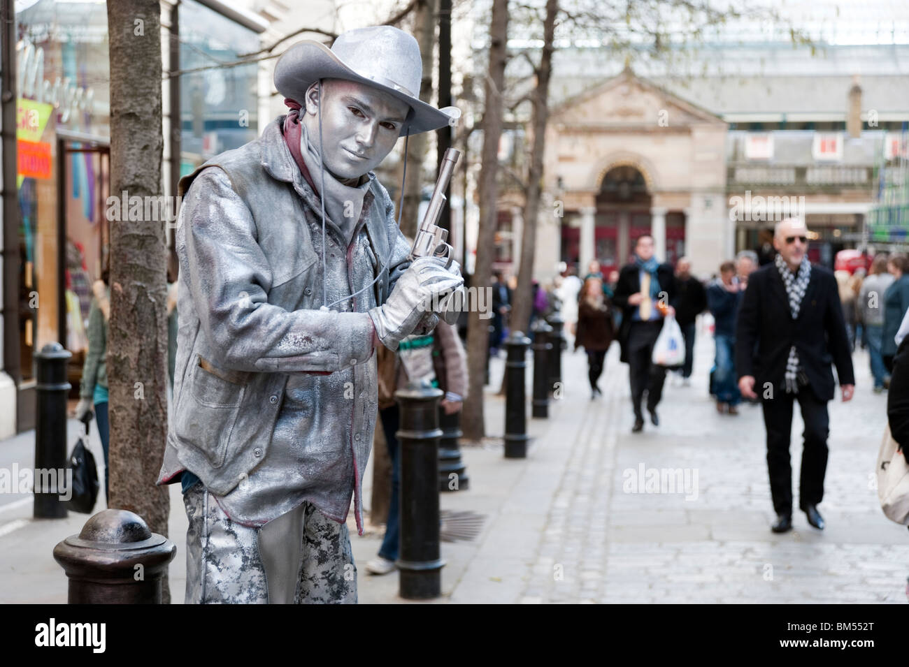 Silver painted human statue of a cowboy in Covent Garden, London, England, UK Stock Photo