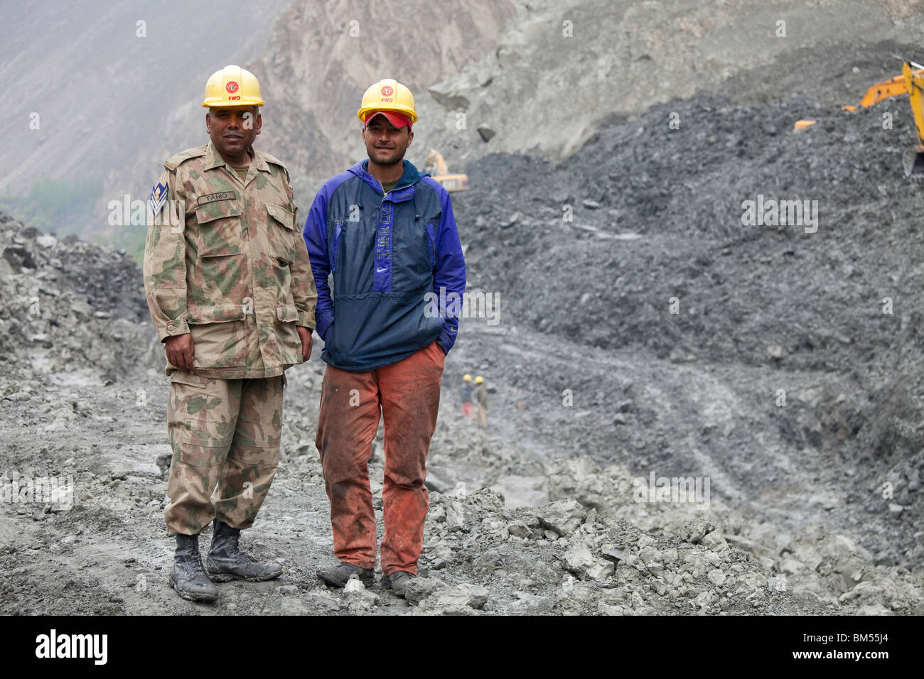 Two army engineers at the landslide area at Attabad which blocks the Karakoram Highway, Hunza, Pakistan Stock Photo