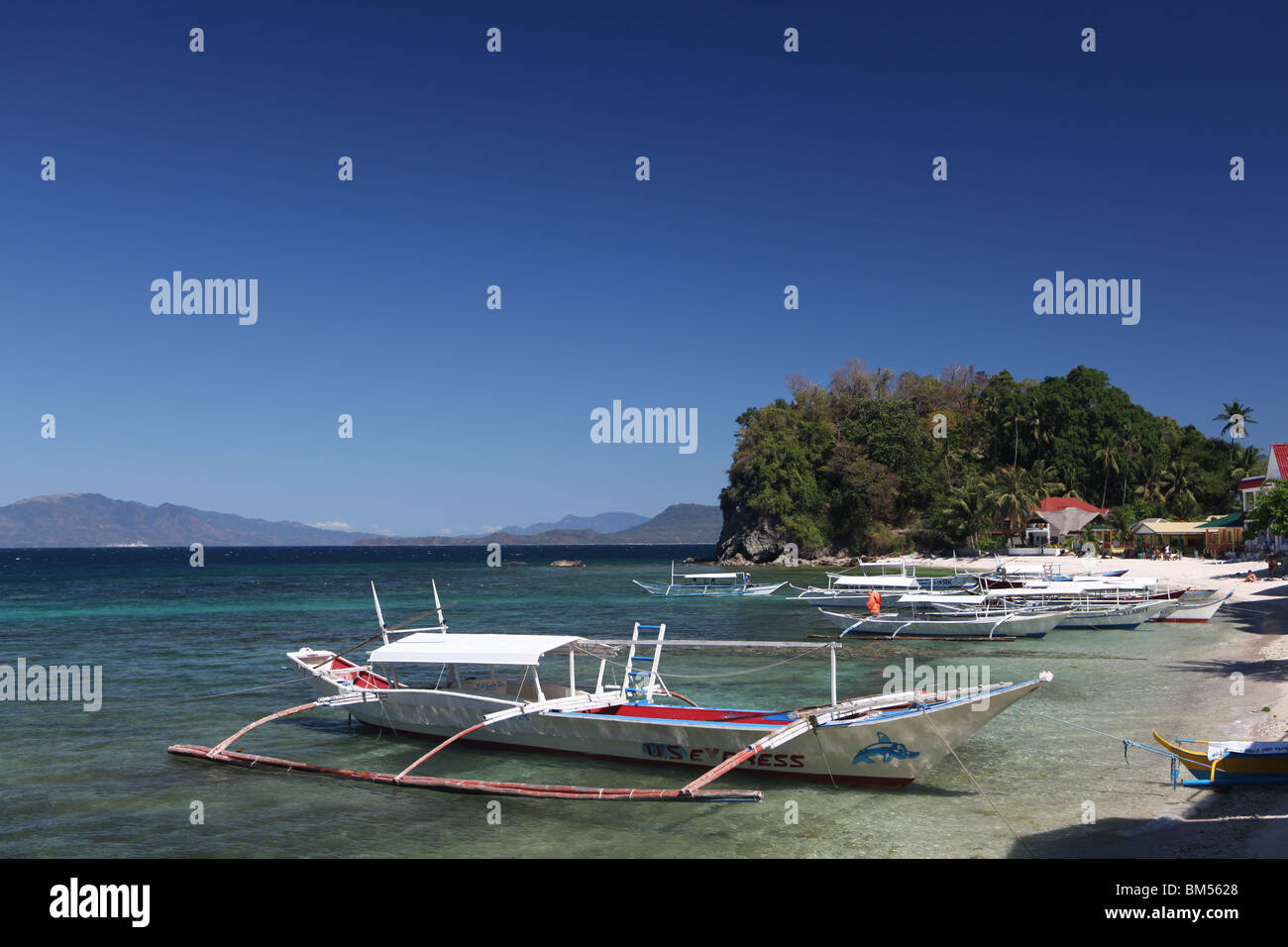Boats moored on Big La Laguna in Puerto Galera, located in the north of Mindoro Occidental in the Philippines. Stock Photo