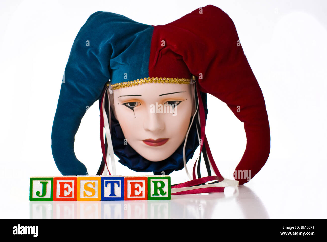 Colorful children's blocks spelling JESTER with a jester's mask Stock