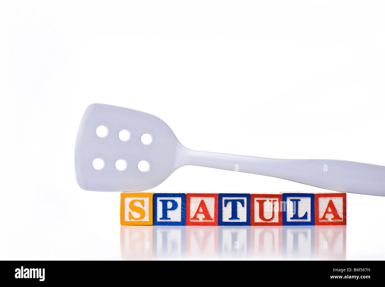 Colorful children's blocks spelling SPATULA with a spatula, flipper or