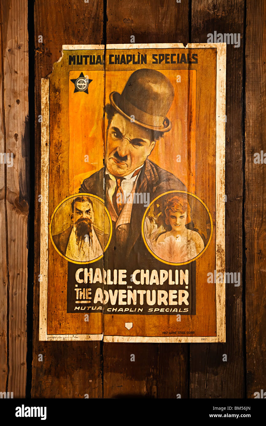 Poster on wood wall for Charlie Chaplin film The Adventurer Stock Photo