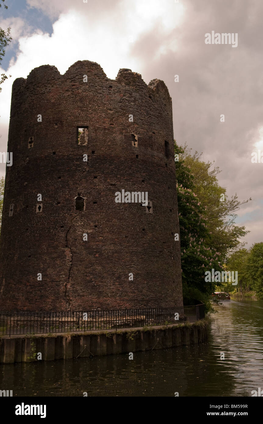 historic brick built tower on the bank of a river Stock Photo