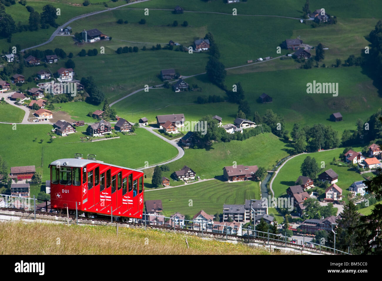 Red funicular railway coming down to Unterwasser, Toggenburg, Switzerland Stock Photo