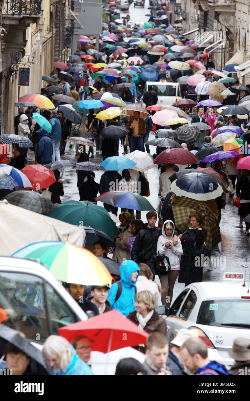 People with umbrellas under the rain. Rome Italy Europe Stock Photo