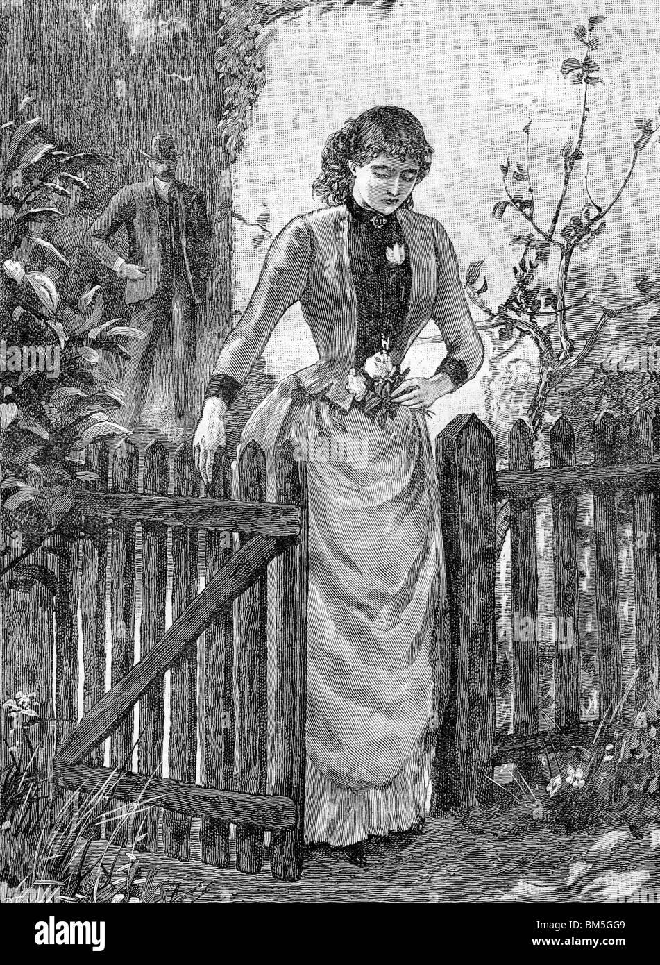Woman walking through a Garden Gate Stock Photo