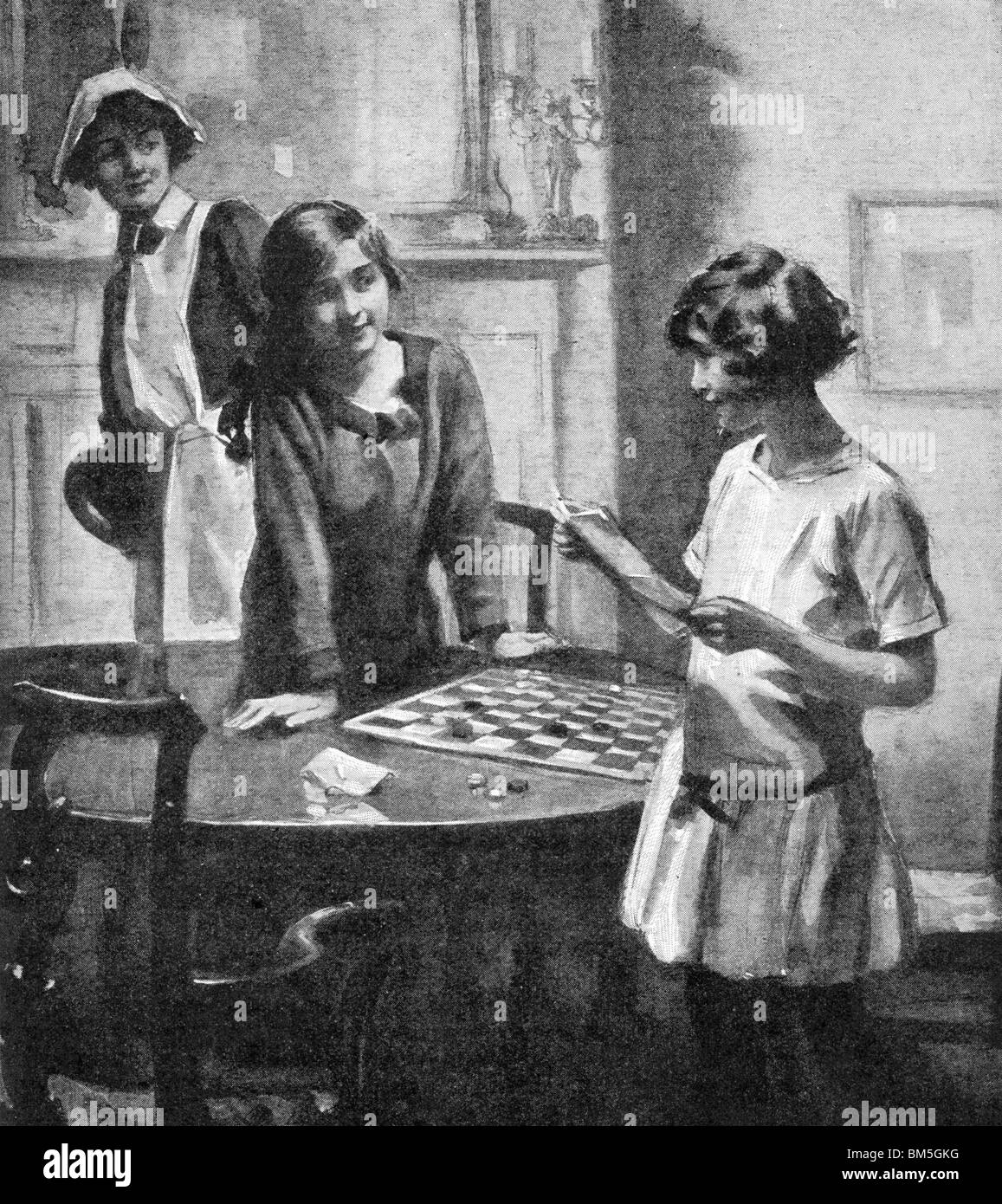 Two Girls Playing Draughts Stock Photo