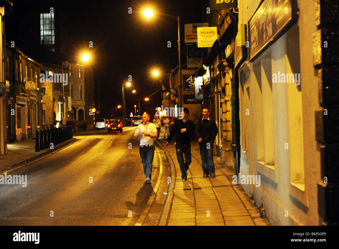 A group of loud drunk boys leave a pub in Skipton Yorkshire Stock Photo