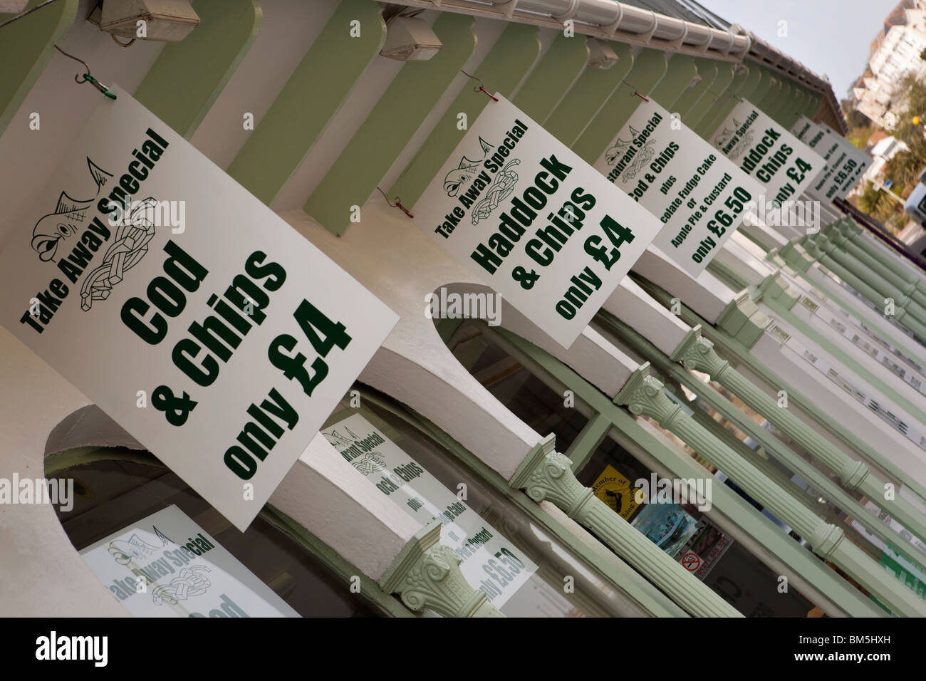 UK, England, Devon, Ilfracombe, promenade, inexpensive take away fish and chips signs Stock Photo