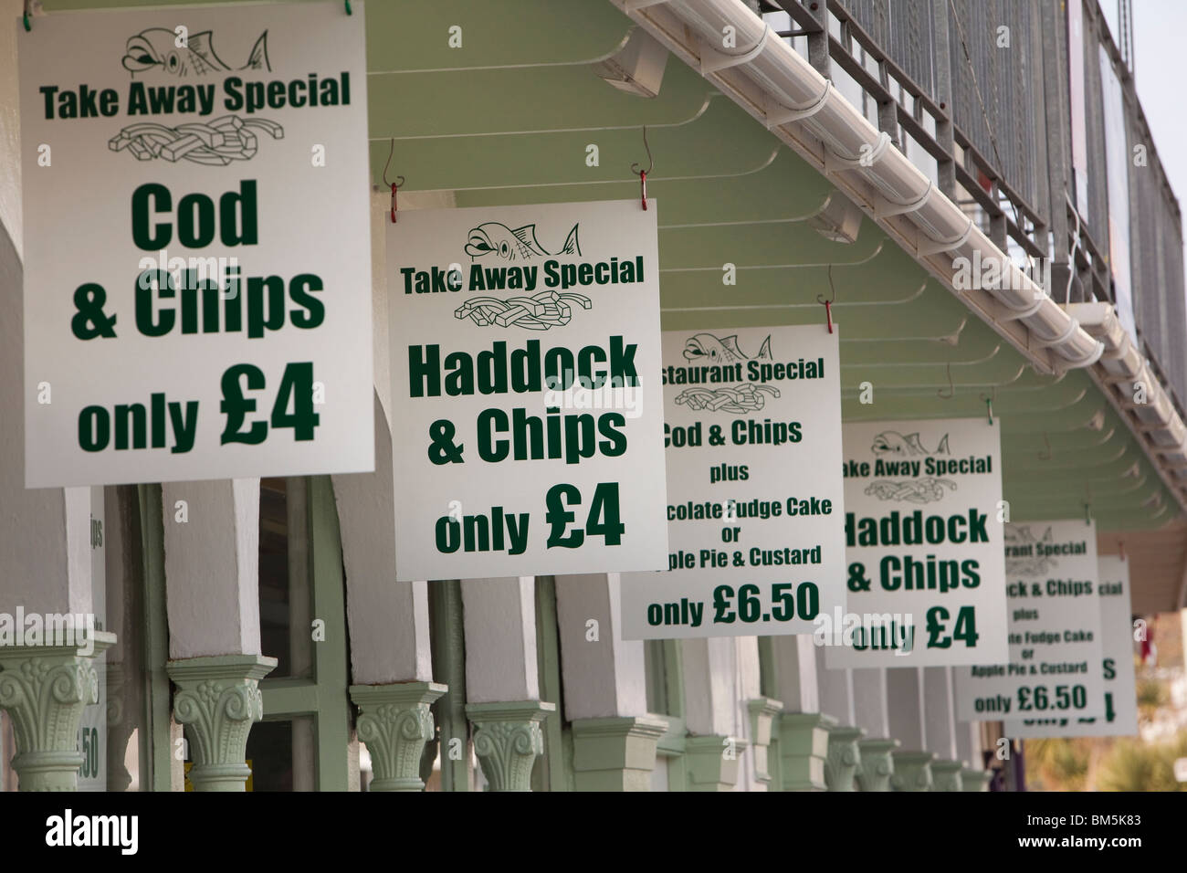UK, England, Devon, Ilfracombe, promenade, inexpensive take away fish and chips signs Stock Photo
