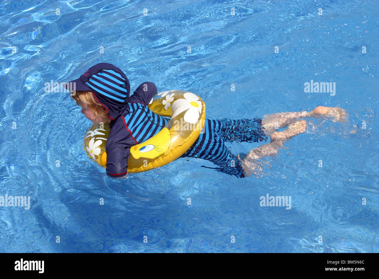 Young Boy swimming with a rubber ring Stock Photo Alamy