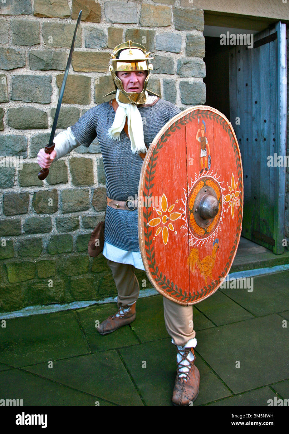 Roman costume dressed soldier in defense position with shield and spear colour Stock Photo