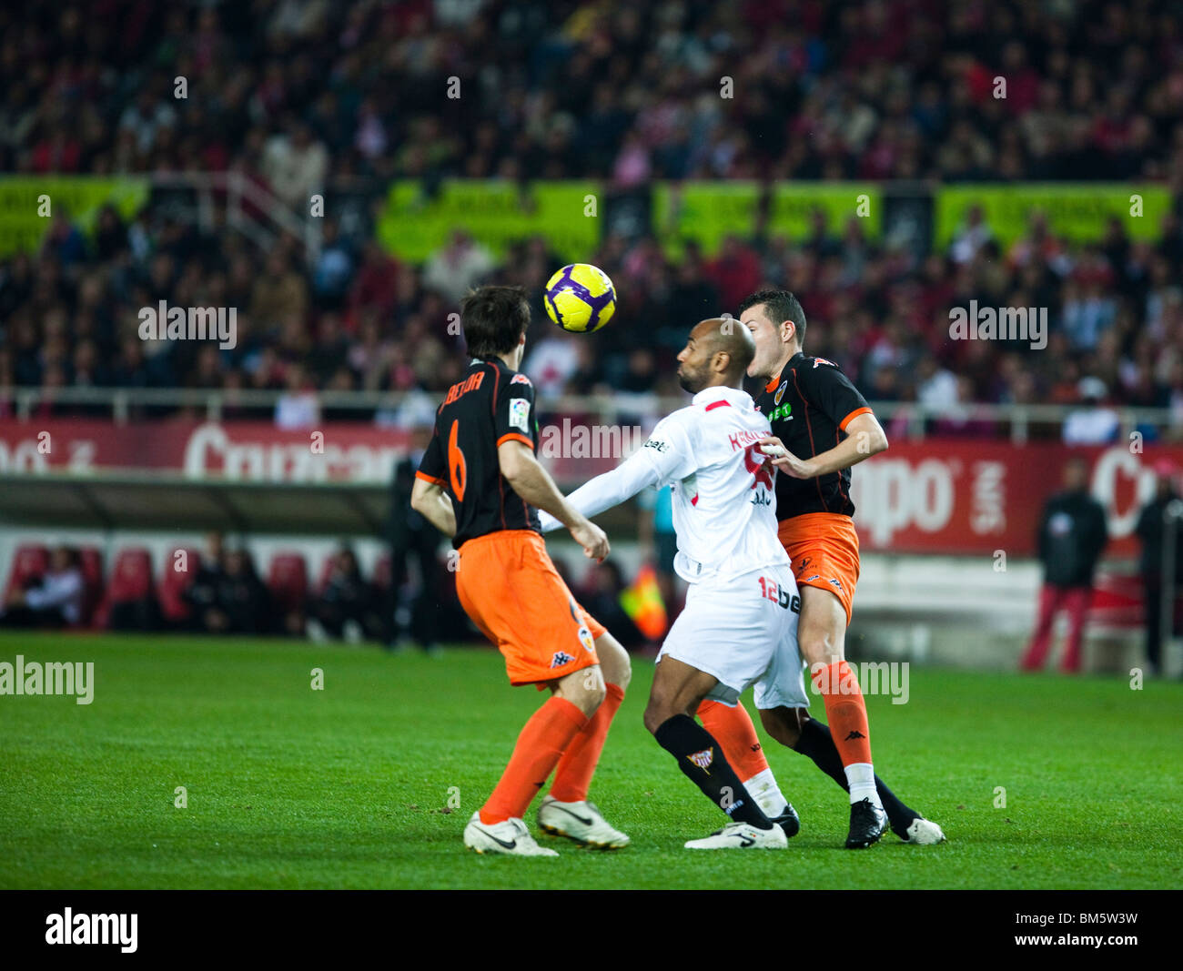 Kanoute fighting for the ball between Albelda (left) and David Navarro. Stock Photo