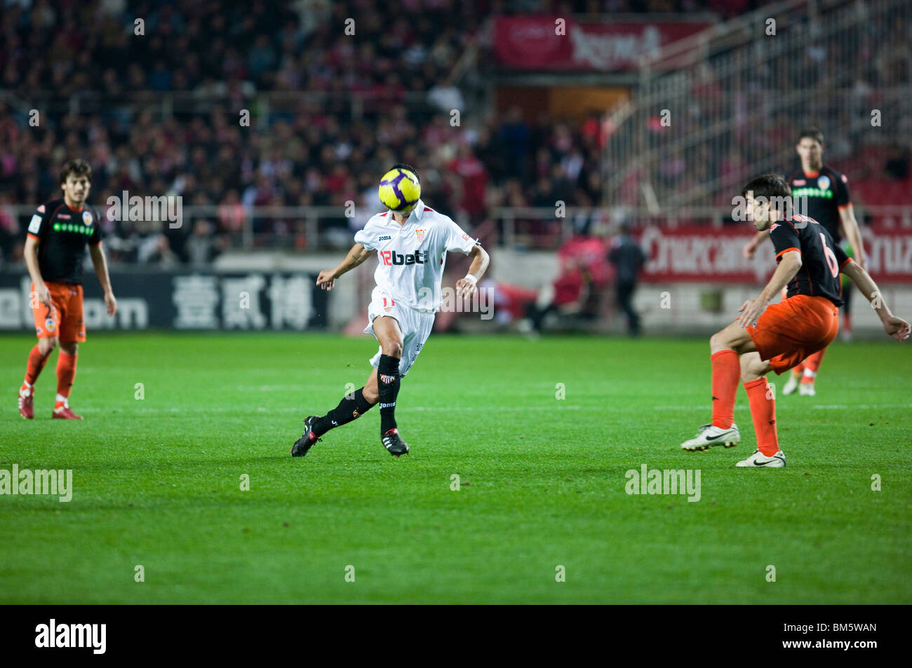 Renato pursues the ball watched by Albelda. Stock Photo