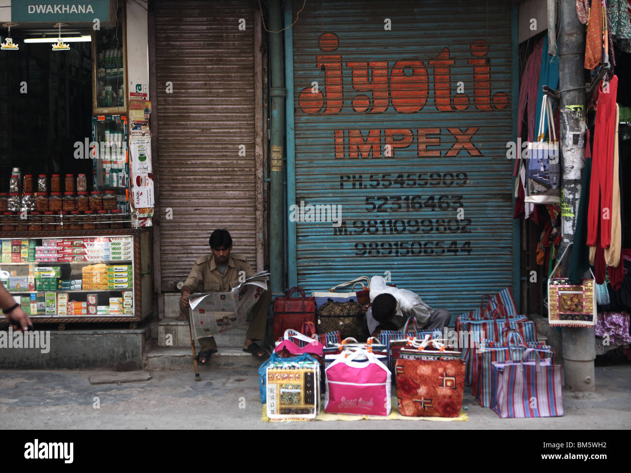 Vendor selling bags in a street market, New Delhi, India Stock