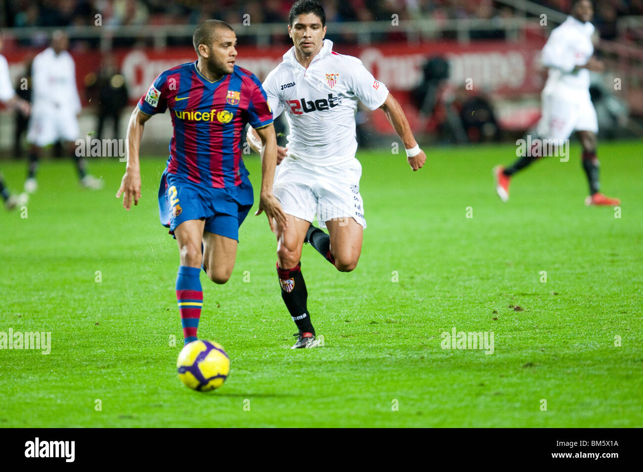 Daniel Alves with the ball pursued by Renato. Stock Photo