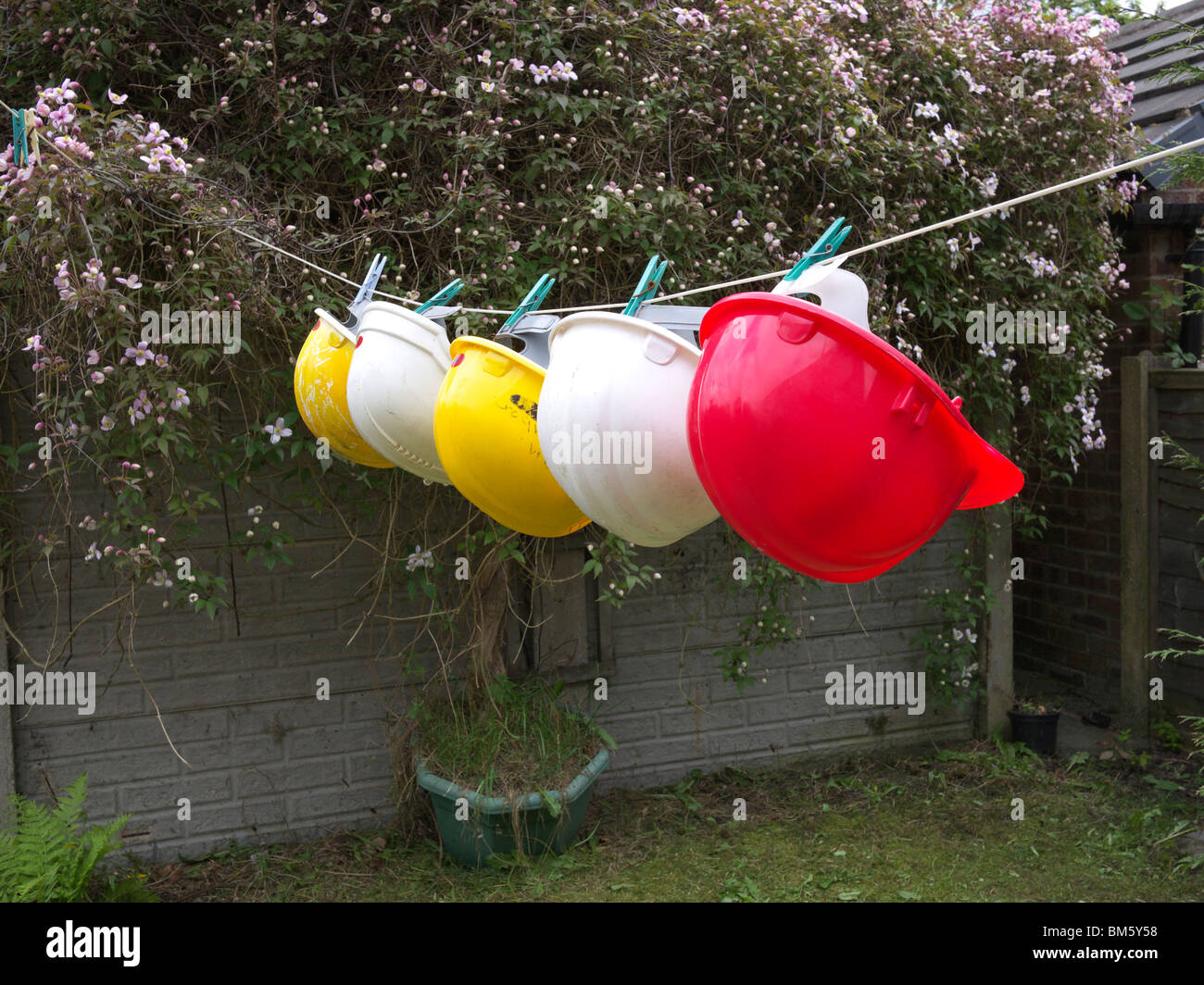 Hard hats on washing line, England,UK Stock Photo Alamy
