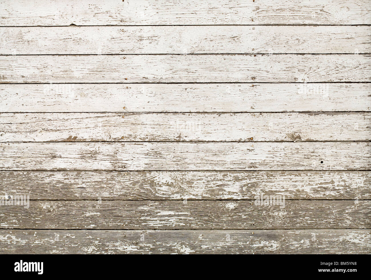 Side of an old white barn, with paint chipped and peeling, Horizontal planks; image can be made vertical. Stock Photo