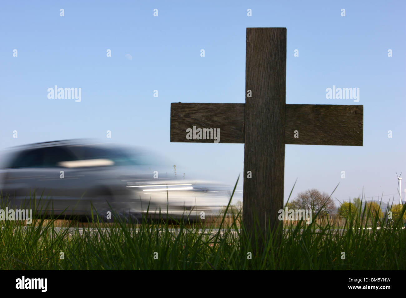 Road side cross, marks a location where a person has been killed in a car crash on a country road. Stock Photo