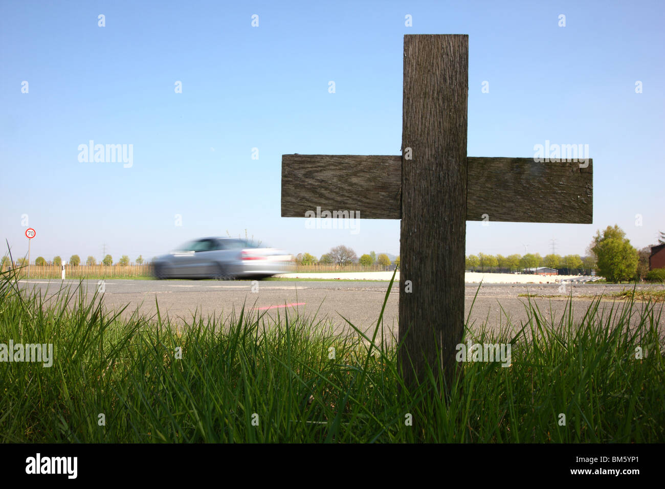 Road side cross, marks a location where a person has been killed in a car crash on a country road. Stock Photo