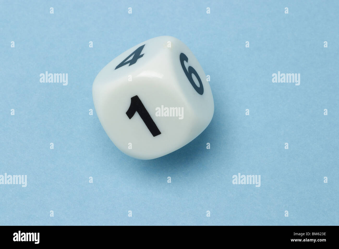 White dice with numbers 1, 4 and 6 on blue background Stock Photo