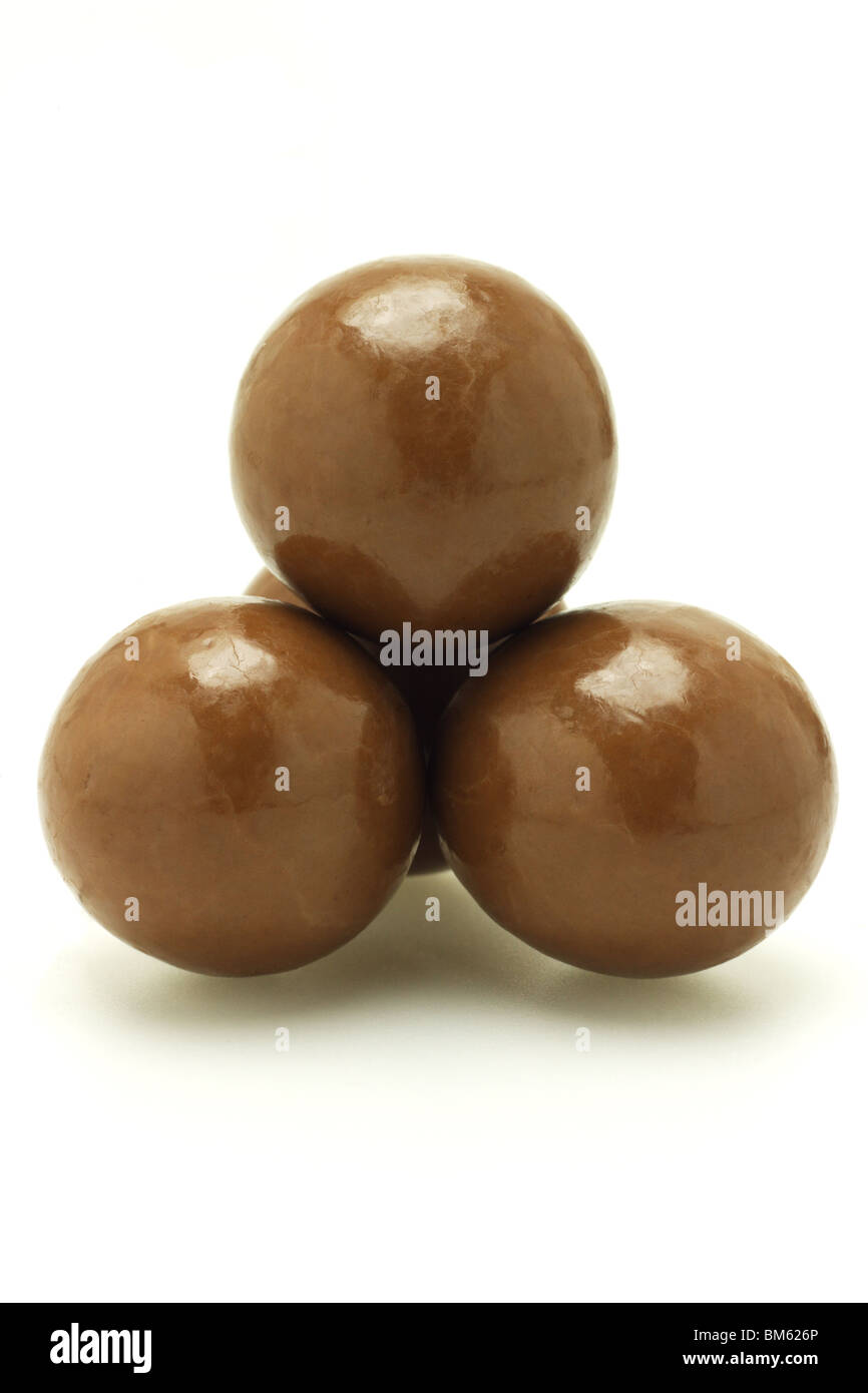 Chocolate balls arranged and stacked on white background Stock Photo