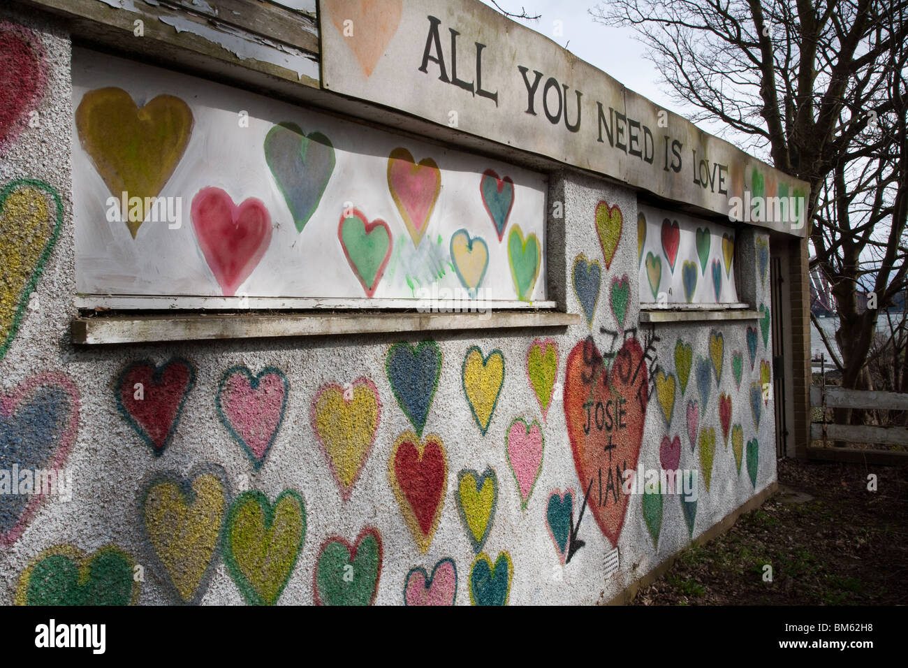 Graffitied wall painted with hearts, shape and designs, South Queensferry, Scotland, UK Stock Photo