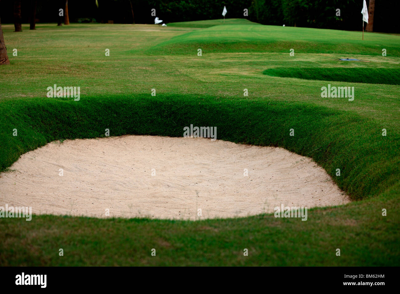 A sand bunker in the golf course Stock Photo - Alamy