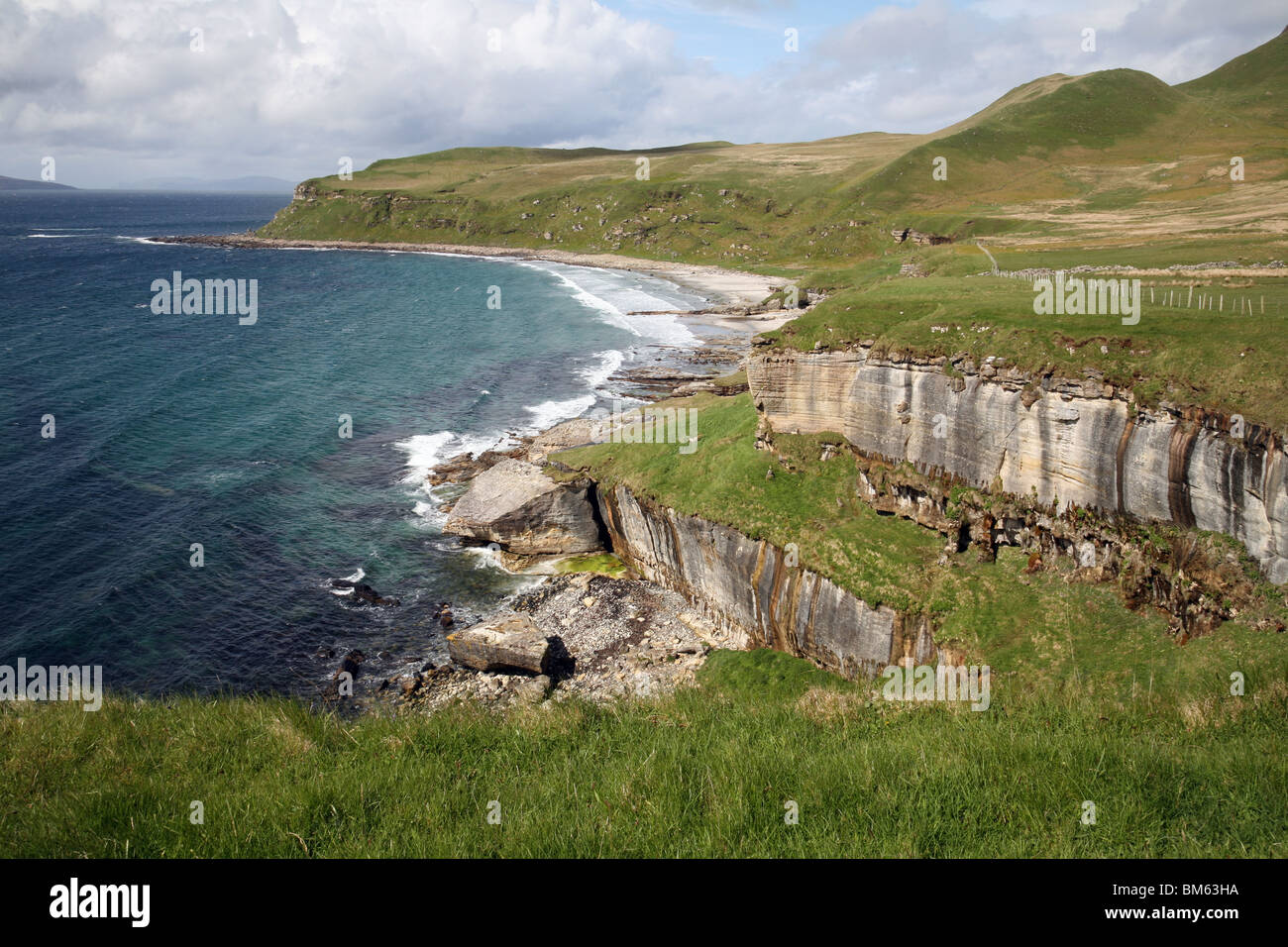 Rocky coastline of the isle of Eigg, looking towards the Isle of Rum, Western Isles, Scotland, UK Stock Photo